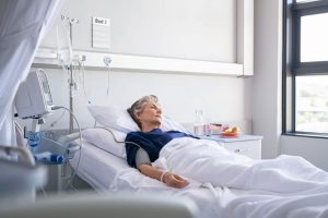 woman ailing in hospital bed