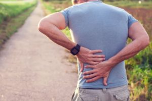 man experiencing a spine injury during a walk