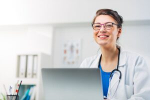 doctor smiling widely in office
