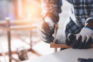 measuring wood to cut in a workshop