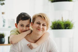 young boy hugging his mother