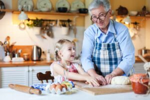 grandmother in the kitchen baking with granddaughter