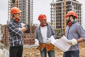 team of construction workers standing and talking