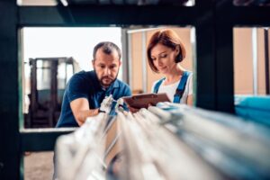 two employees taking inventory in warehouse