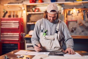 a carpenter at work surrounded by his tools
