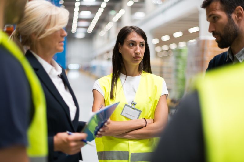 Manager talking to team of employees at work