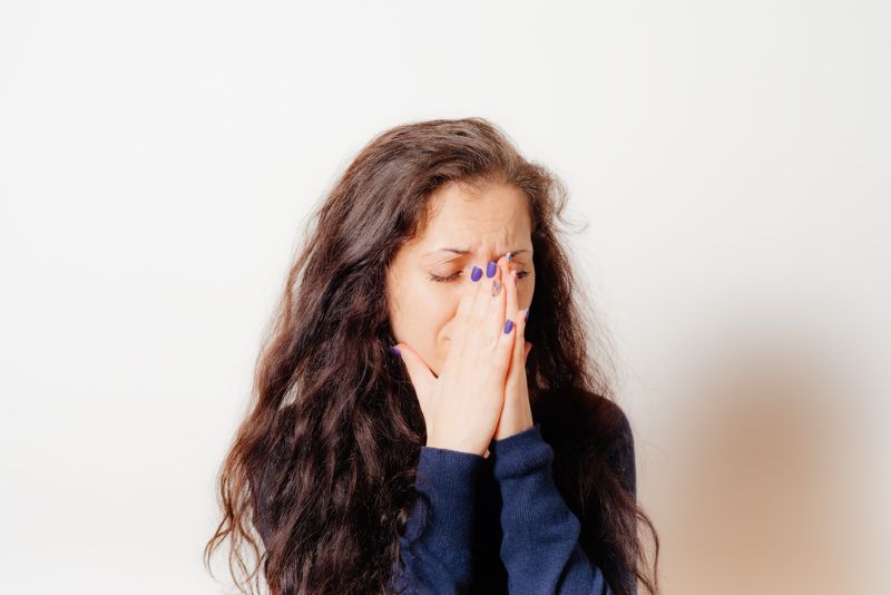 Sad woman covering her face while crying